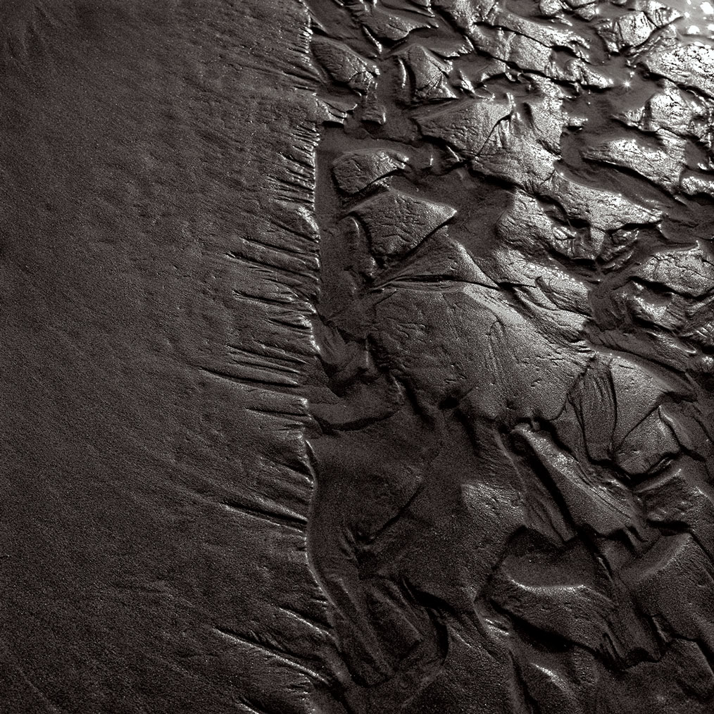 Photographie numérique du passage de l'eau dans le sable