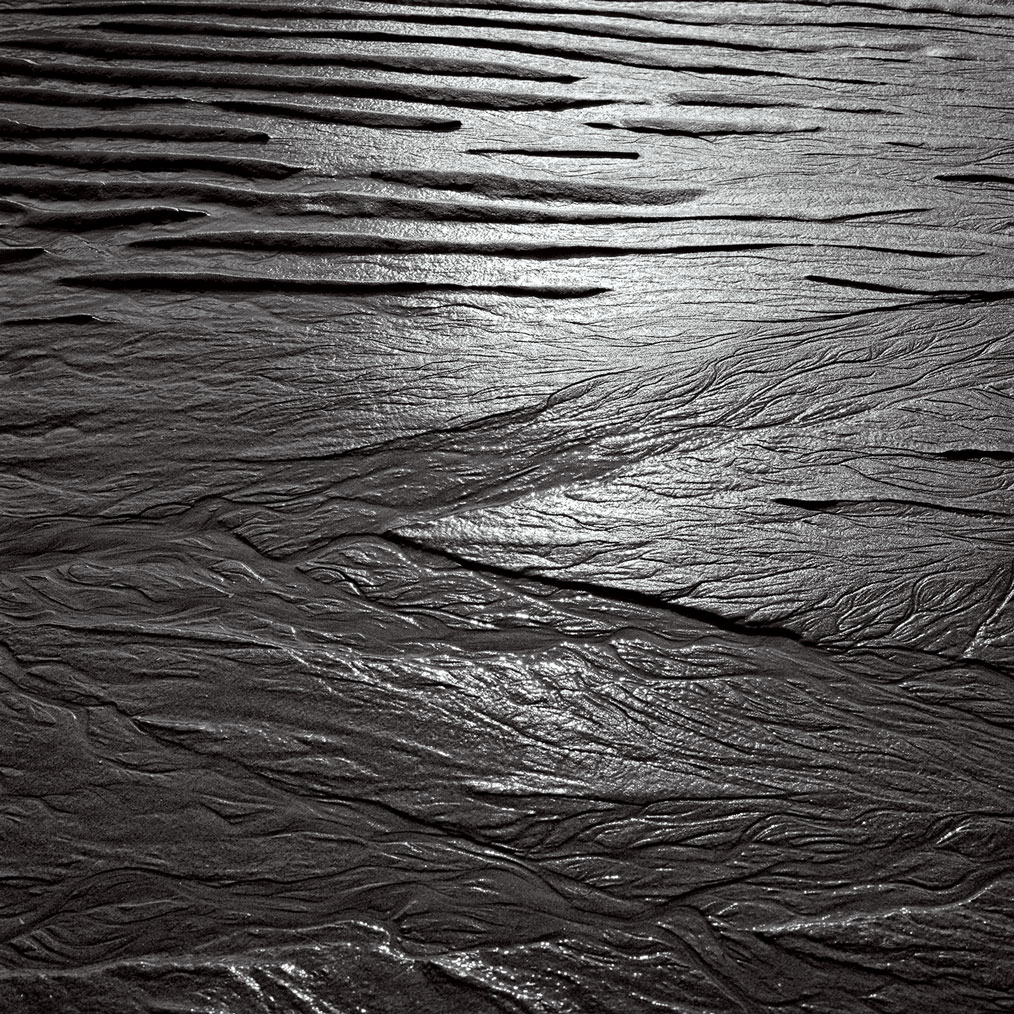 Photographie numérique des marques laissées par l'eau dans le sable à Ault